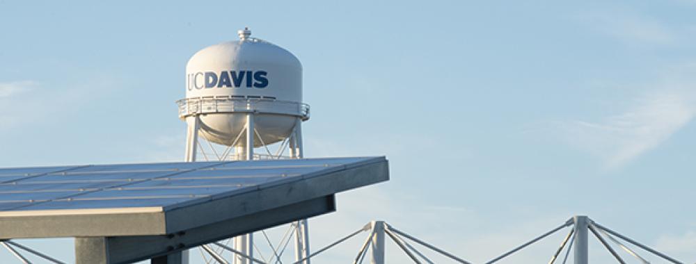 Image of UC Davis watertower with solar panels in foreground.