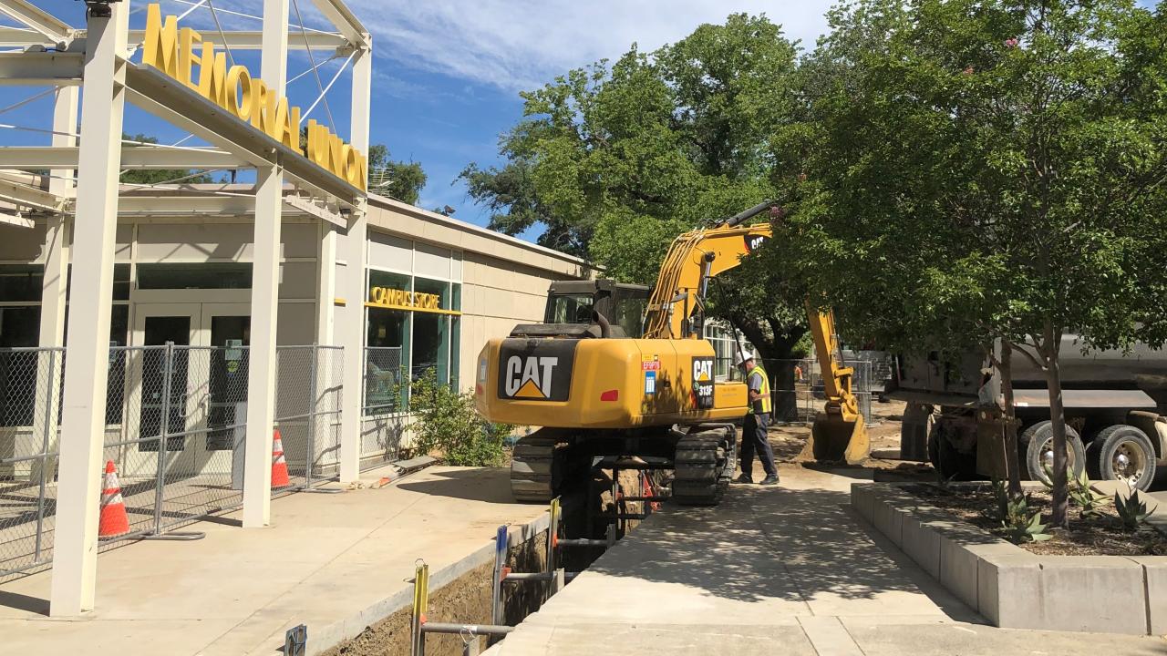 Excavating a trench between East Quad and the Memorial Union