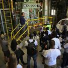 Joshua Moorejohn showing a boiler on a facilities tour